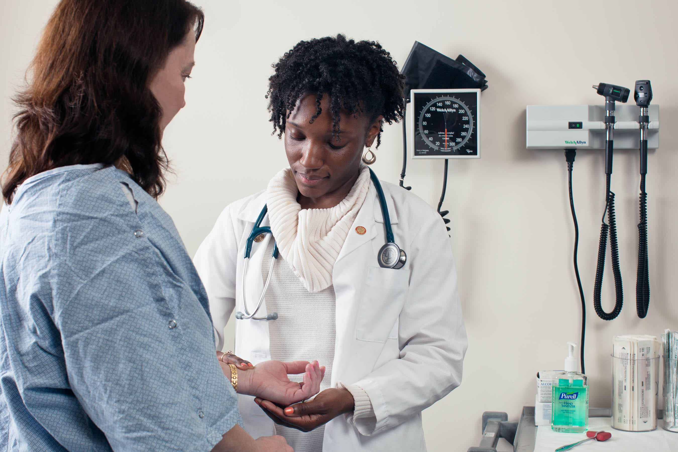 Medical school student examining a patient